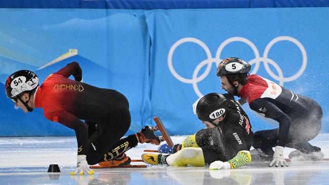 China's Ren Ziwei, Australia's Brendan Corey and Netherlands' Itzhak De Laat fall in the final turn. Picture: AFP.