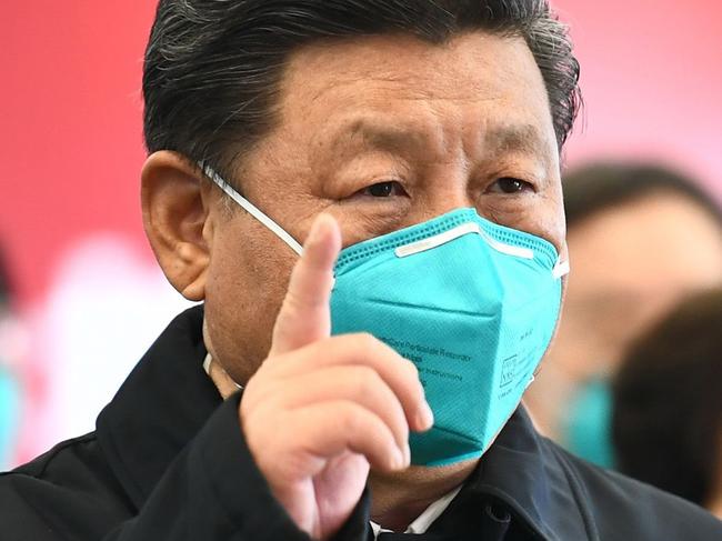 This photo released on March 10, 2020 by China's Xinhua News Agency shows Chinese President Xi Jinping wearing a mask as he GESTURES to a coronavirus patient and medical staff via a video link at the Huoshenshan hospital in Wuhan, in China's central Hubei province on March 10, 2020. (Photo by Xie Huanchi / XINHUA / AFP) / China OUT - Hong Kong OUT - Japan OUT - Germany OUT - United States OUT - United Kingdom OUT / -----EDITORS NOTE---- RESTRICTED TO EDITORIAL USE - ONE TIME USE - MANDATORY CREDIT "AFP PHOTO/XINHUA / XIE HUANCHI" - NO MARKETING NO ADVERTISING CAMPAIGNS - DISTRIBUTED AS A SERVICE TO CLIENTS - NO ARCHIVES /