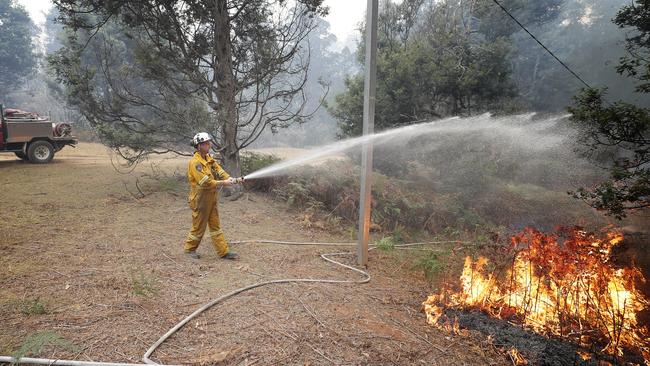 TFS crews conduct a controlled burn in Donnelly's Road, Geeveston to protect a house. Picture: RICHARD JUPE