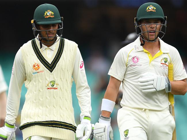 Usman Khawaja and Marcus Harris of Australia leave the field as the tea break is called early due to bad light, on day four of the Fourth Test match between Australia and India at the SCG in Sydney, Sunday, January 6, 2019. (AAP Image/Dan Himbrechts) NO ARCHIVING, EDITORIAL USE ONLY, IMAGES TO BE USED FOR NEWS REPORTING PURPOSES ONLY, NO COMMERCIAL USE WHATSOEVER, NO USE IN BOOKS WITHOUT PRIOR WRITTEN CONSENT FROM AAP