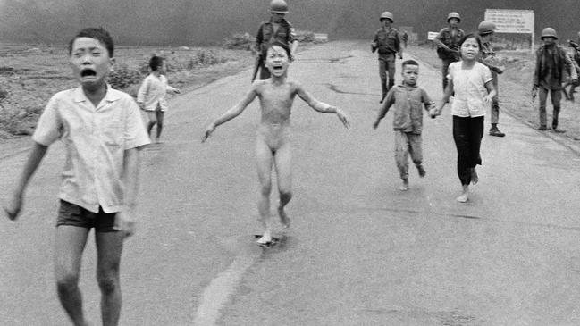 South Vietnamese forces follow after terrified children, including nine-year-old Kim Phuc, centre, as they run down Route 1 near Trang Bang after an aerial napalm attack on suspected Vietcong hiding places, June 8, 1972. (AP Photo/Nick Ut)