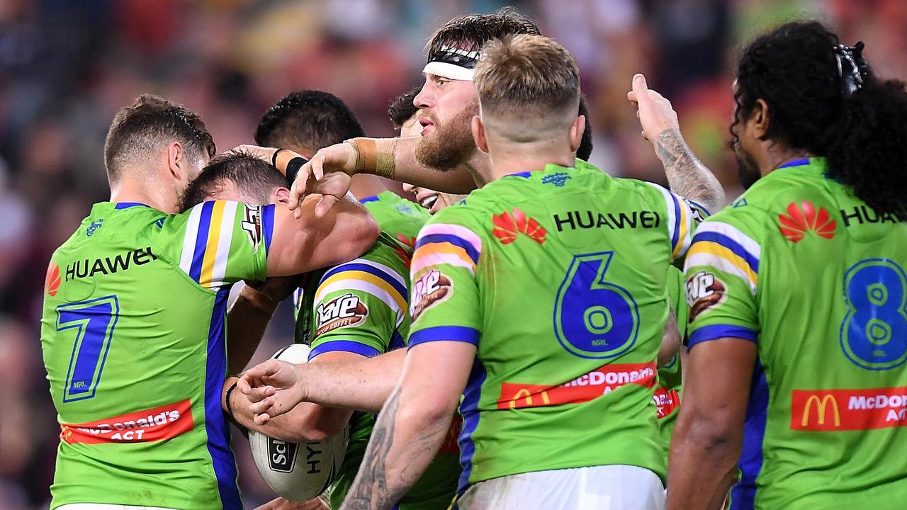 Josh Hodgson of the Raiders is congratulated by teammates after scoring a try.