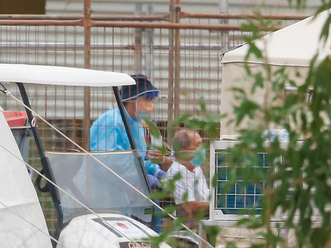 An elderly traveller who tested positive for the coronavirus is evacuated from the Howard Springs Quarantine Facility. Picture: Glenn Campbell