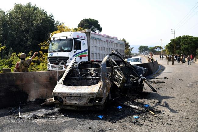 Lebanese soldiers secure the site of an Israeli drone attack that targeted a vehicle on the international Beirut-Damascus road in the area of Araya east of Beirut on October 31, 2024, amid the ongoing war between Israel and Hezbollah.