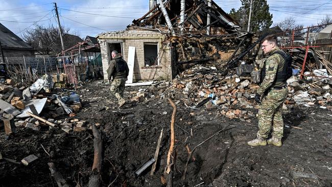 Ukrainian forces survey the site of a Russian strike that used an Iranian-made drone. Picture: Zuma Press/WSJ