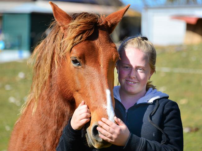 Brieanna Hepburn patting “Spice” who was rescued six years ago. Picture: Judy Goggin