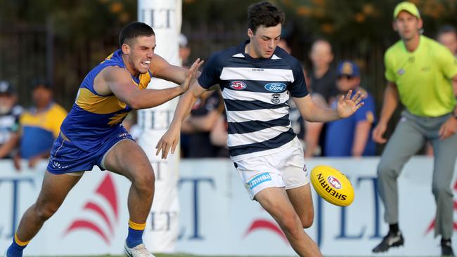 Jordan Clark gets a kick away under pressure in his first JLT Series game against West Coast. Picture: Richard Wainwright. 