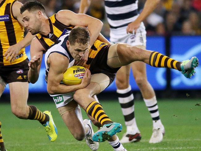 Jack Gunston tackles Joel Selwood. Picture: Colleen Petch