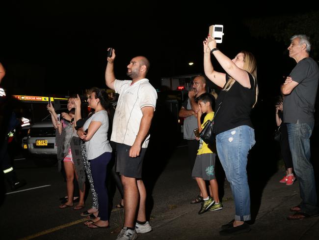 People evacuated and locals watched on. Picture: Bill Hearne