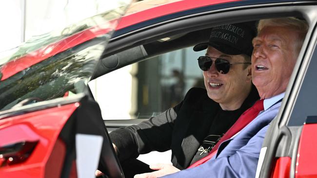 US President Donald Trump and Tesla CEO Elon Musk speak to the press as they sit in a Tesla vehicle on the South Portico of the White House on March 11, 2025 in Washington, DC. (Photo by Mandel NGAN / AFP)