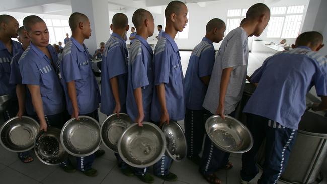 Inmates line up to get lunch at the Chongqing Juvenile Offender Correctional Center in Chongqing Municipality, China. Picture: Getty Images.