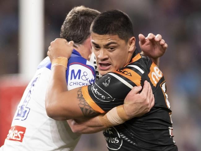 Tommy Talau of the Tigers is tackled during the Round 7 NRL match between the Canterbury-Bankstown Bulldogs and the Wests Tigers at Bankwest Stadium in Sydney, Sunday, June 28, 2020. (AAP Image/Craig Golding) NO ARCHIVING, EDITORIAL USE ONLY