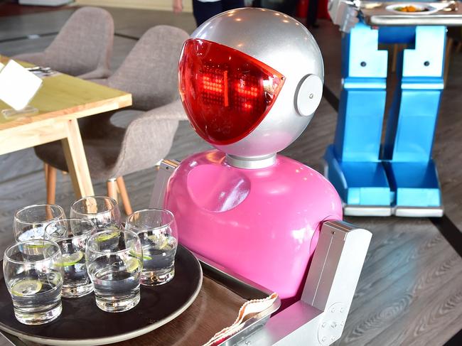 YIWU, CHINA - MAY 18: (CHINA OUT) A couple of robot waiters deliver meals for customers at robot-themed restaurant on May 18, 2015 in Yiwu, Zhejiang province of China. Sophomore Xu Jinjin in 22 years old from Hospitality Management of Yiwu Industrial and Commercial College managed a restaurant where a pair of robot acted as waiters. The "male" one was named "Little Blue" (for in blue color) and the "female" one was "Little Peach" (for in pink) and they could help order meals and then delivered them to customers along the magnetic track and said: "Here're your meals, please enjoy". According to Xu Jinjin, They had contacted with the designer to present more robot waiters to make the restaurant a real one that depends completely on robots. (Photo by ChinaFotoPress via Getty Images)