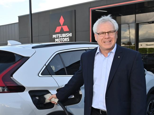 16/4/21. Mitsubishi Australia CEO Shaun Westcott at the new HQ in Adelaide Airport.Shaun with an Eclipse Cross PHEV car and the bidirectional charger.Picture: Keryn Stevens