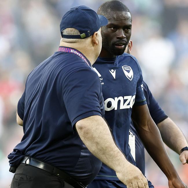 Jason Geria is escorted from the pitch.