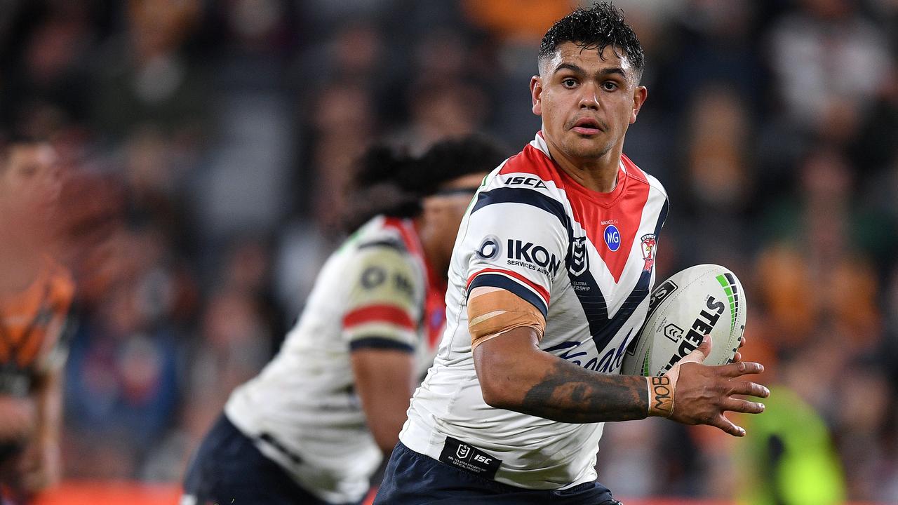 Latrell Mitchell of the Roosters makes a break against the Wests Tigers