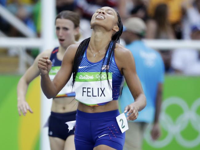 Allyson Felix throws her head back in anguish.