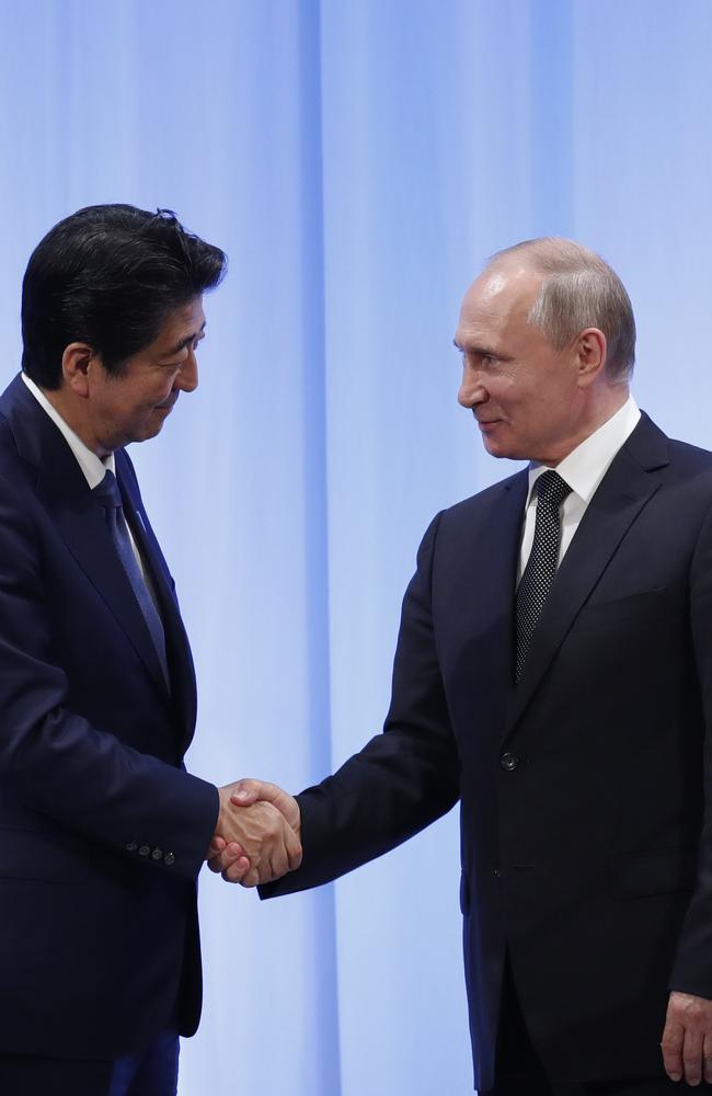 Russian President Vladimir Putin (R) shakes hands with Japanese Prime Minister Shinzo Abe at their news conference at G20 leaders summit on June 29, 2019 in Osaka, Japan. Picture: Kim Kyung-Hoon/Getty Images