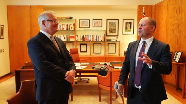 Prime Minister Scott Morrison and Treasurer Josh Frydenberg work in the Prime Minister’s office in Canberra before heading out and announcing the $17.6bn stimulus package to help the economy during the coronavirus outbreak. Picture: Adam Taylor/PMO