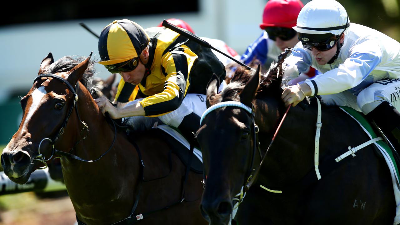 James Innes (white cap) rides ANDSOITISWRITTEN down the outside to beat the favorite CHEEKY BABE ridden by Blake Shinn at Canterbury Racecourse , Canterbury.Picture Gregg Porteous