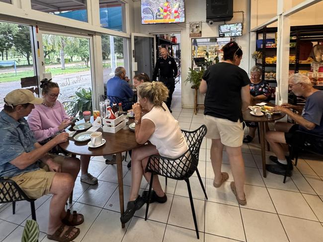 Stranded travellers gathered at the Greenvale Roadhouse on February 9, appreciating donations from the community. Picture: Supplied.