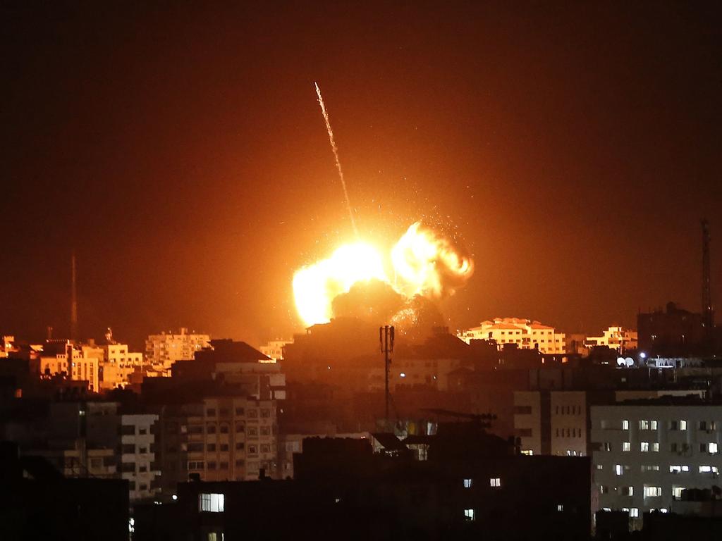 A ball of fire lights the sky above a building believed to house the offices of Hamas chief in Gaza, Ismail Haniyeh, during Israeli strikes on the Gaza City. Picture: AFP