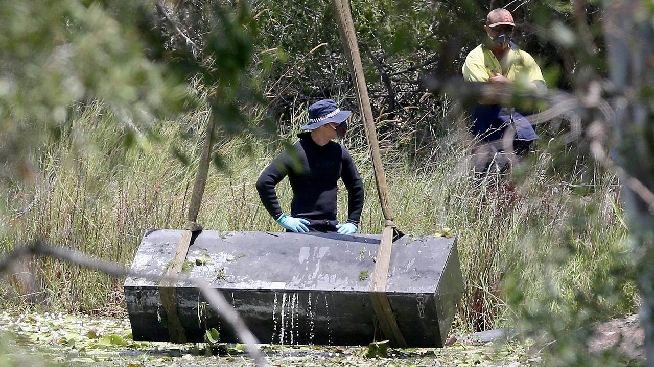 The metal box the two were locked in is pulled from a dam in Kingston. Photo: Jono Searle.