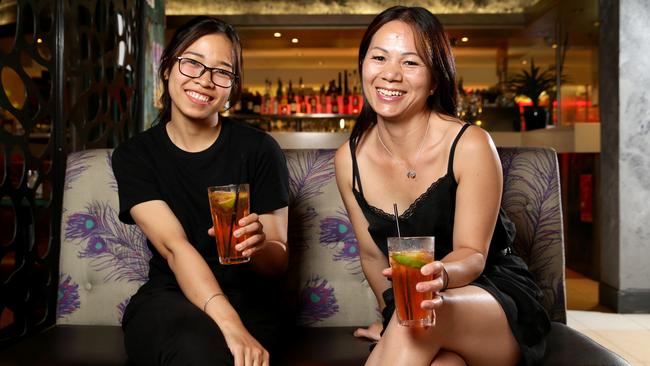 Bell Pham and Von Huyn enjoying a lemon, lime and bitters. Ms Huyn considers it non-alcoholic. Picture: Jonathan Ng