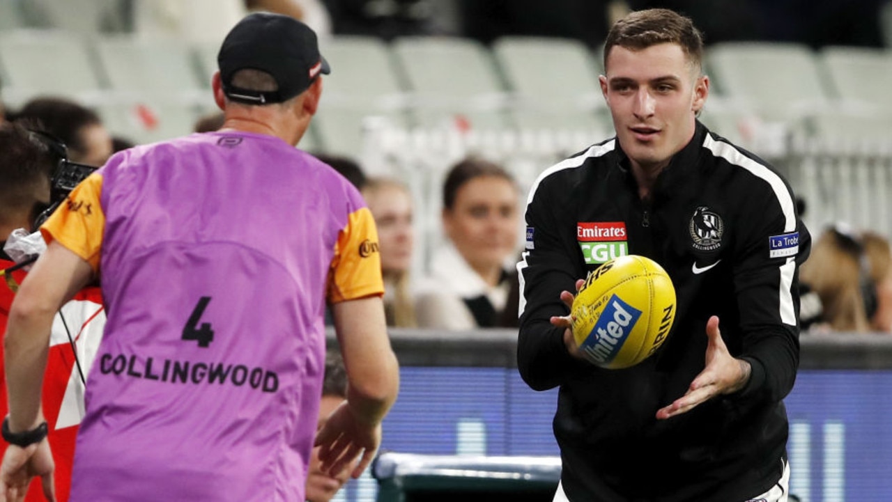 MELBOURNE, AUSTRALIA - MARCH 25: Trey Ruscoe of the Magpies is seen warming up as the medical sub during the 2021 AFL Round 02 match between the Carlton Blues and the Collingwood Magpies at the Melbourne Cricket Ground on March 25, 2021 in Melbourne, Australia. (Photo by Dylan Burns/AFL Photos via Getty Images)