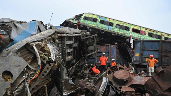 Rescue workers sift through the wreckage. Picture: AFP