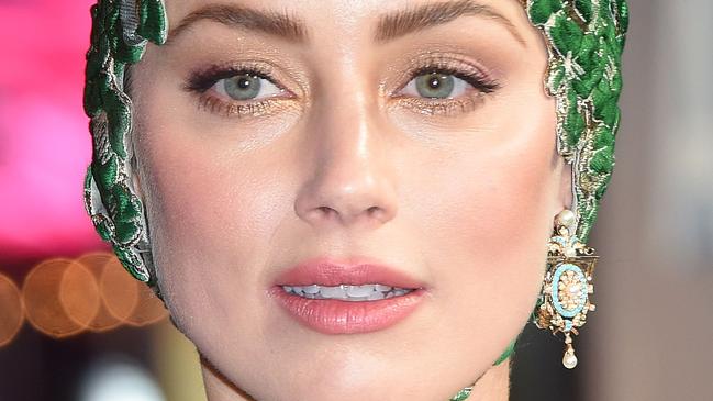 US actor Amber Heard poses upon arrival to attend the World Premiere of the film "Aquaman" in London on November 26, 2018. (Photo by Anthony HARVEY / AFP)