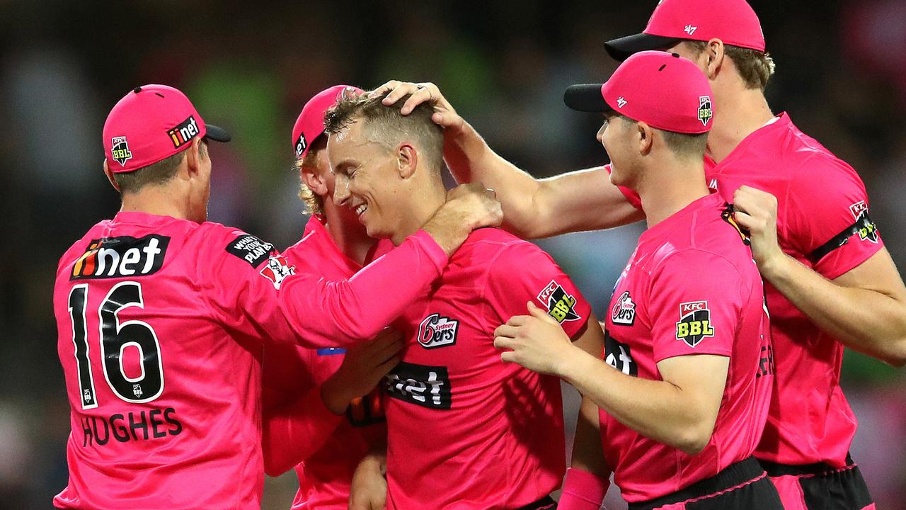 Tom Curran is congratulated by his Sixers teammates after a wicket during the Sydney Smash. Picture: Phil Hillyard.