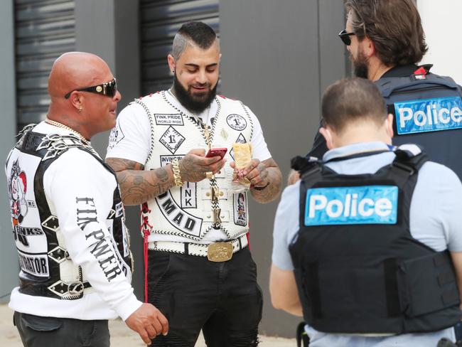 Police chat to Kosh Radford (left) at the Finks Cranbourne West clubhouse. Picture: David Crosling