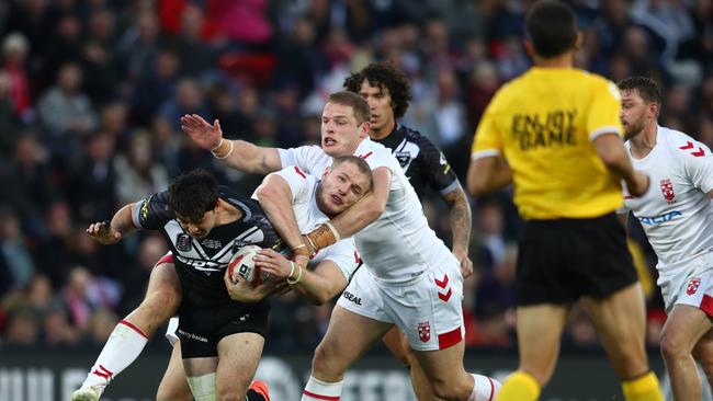 LIVERPOOL, ENGLAND — NOVEMBER 04: Brandon Smith of New Zealand is tackled by Tom Burgess and George Burgess of England during the International Series second test match between England and New Zealand at Anfield on November 4, 2018 in Liverpool, England. (Photo by Michael Steele/Getty Images)