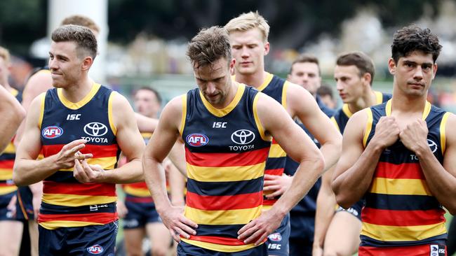 Crows players leave the field dejected after their close loss to Essendon. Picture: Sarah Reed