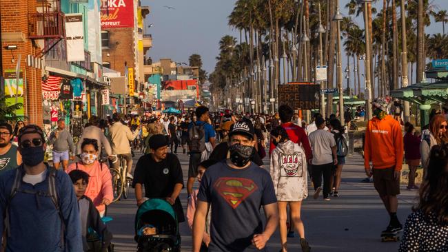 People walk at the boardwalk in Venice Beach, Los Angeles. Picture: AFP