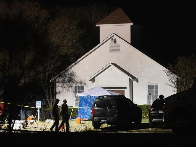 Law enforcement officials continue their investigation at Sutherland Springs Baptist Church during the early morning hours Monday. Picture: Scott Olson/Getty Images/AFP