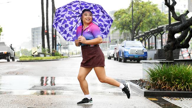 Andrea Pascual, tries to keep dry as she dashes to work at Baskin Robbins in the city. Picture: Shae Beplate