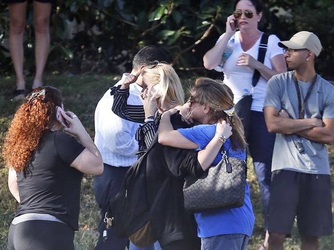 Anxious family members wait for news as the school remained in lockdown. Picture: Wilfredo Lee/AP