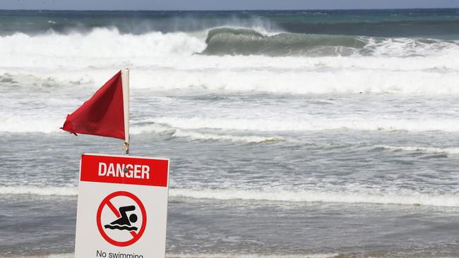 Tourists and locals watch on as giant surf pounds Gold Coasts northern beaches. Picture Glenn Hampson