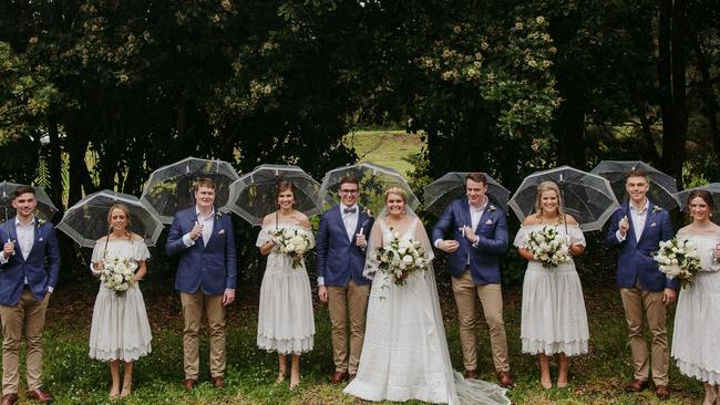 Wedding in the rain: Amelia Small and Jackson Law with their bridesmaids and groomsmen. Pic: Shane Shepherd