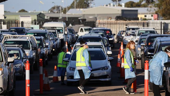 Long lines of cars queue at the McDonald Jones Stadium in Newcastle for Covid-19 drive-through testing. Picture: David Swift