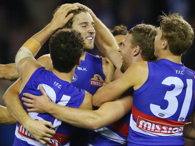 M Marcus Bontempelli is flocked by teammates after kicking the sealer. Photo: Michael Dodge/Getty Images