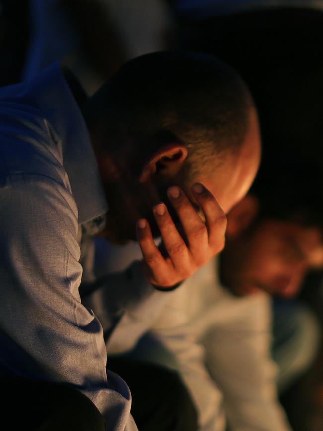 Mourners gather at the memorial Saturday night.