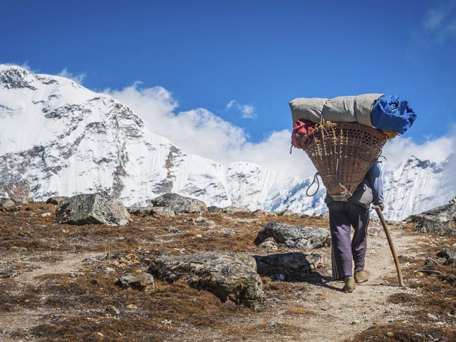 ESCAPE: INTREPID NEPAL .. Matt Johnston story .. a sherpa leads the way with his heavy load strapped to his head. Picture: iStock