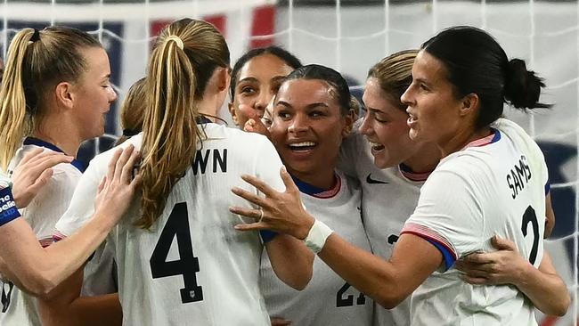 USA's players celebrate a goal by forward #21 Michelle Cooper (3rd R) during the SheBelieves Cup. (Photo by Patrick T. Fallon / AFP)