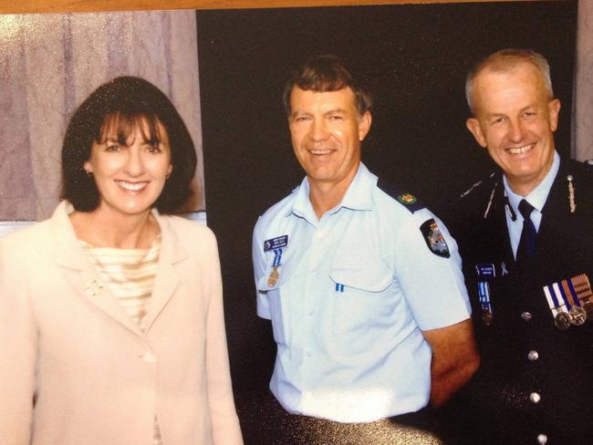 Officer-in-charge of Ayr police station, Senior Sergeant Michael Isles, pictured with then-Minister for Police and Corrective Services, Judy Spence and then-Commissioner of Police Bob Atkinson in 2008. Snr Sgt Isles went missing on duty in Ayr in 2009. Picture: Isles family/Facebook