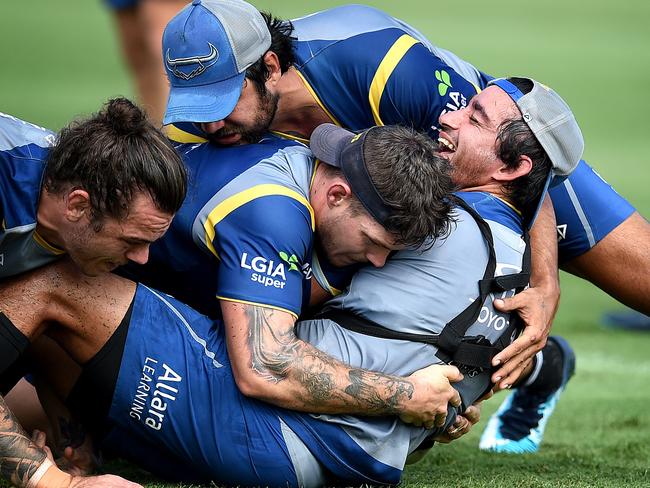 Johnathan Thurston tackled by Ethan Lowe, Ben Hampton and Javid Bowen at Cowboys Pre-Season Training. Picture: Alix Sweeney