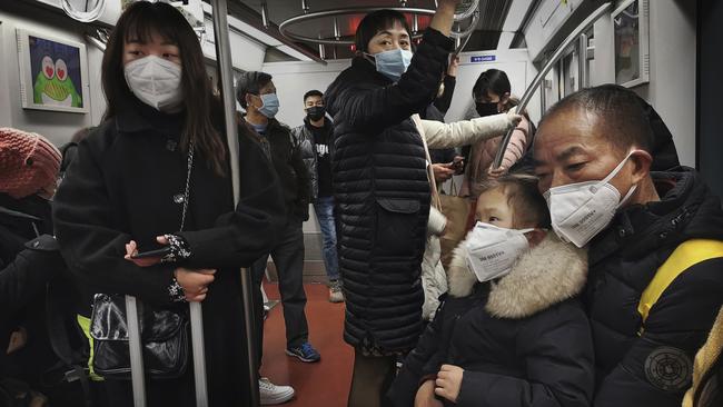 Commuters in Beijing, China. Picture: Getty/Kevin Frayer