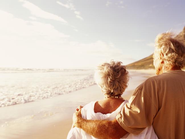 Senior couple embracing on beach, rear viewretirees thinkstockolder couple walking on the beachsuperannuation genericelderly, active, wealth, couple, aging, beach, cancer